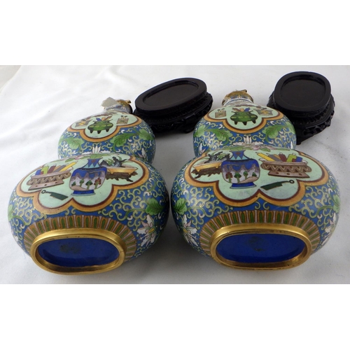 111 - A pair of Chinese cloisonné  double gourd shaped flasks with carved stands.  Each 33cm tall on stand... 