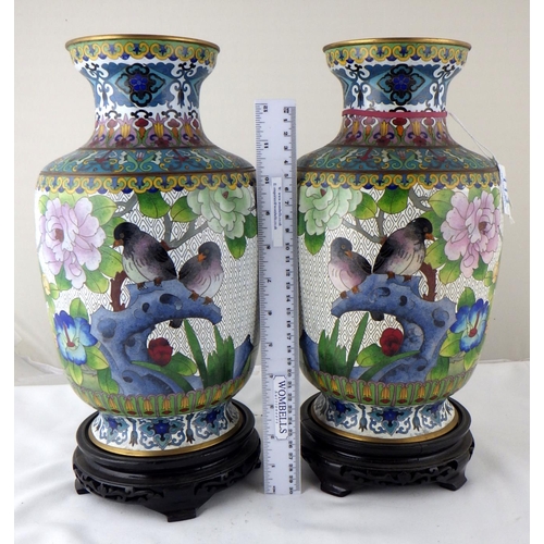 113 - A pair of Chinese cloisonné enamel vases having carved bases. Each 35cm total height