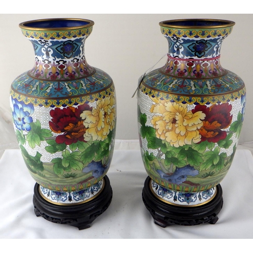 113 - A pair of Chinese cloisonné enamel vases having carved bases. Each 35cm total height