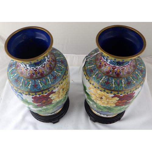 113 - A pair of Chinese cloisonné enamel vases having carved bases. Each 35cm total height