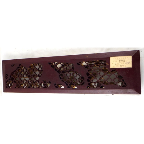 144 - A Chinese panel carved with birds and foliage, black and gold finish.  58 x 15cm.  A/F