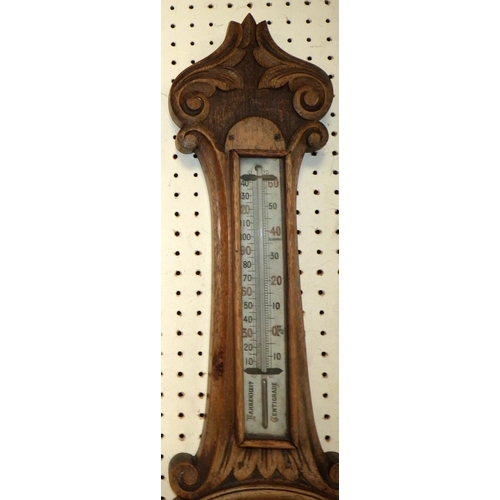 157 - An oak cased wall barometer, 81cm tall.