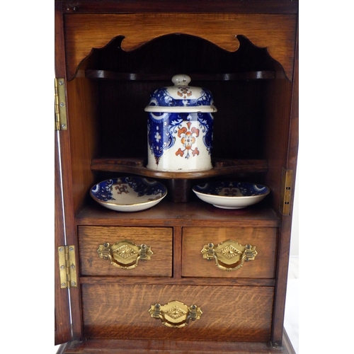 160 - An oak smokers' cabinet, interior pot cracked.