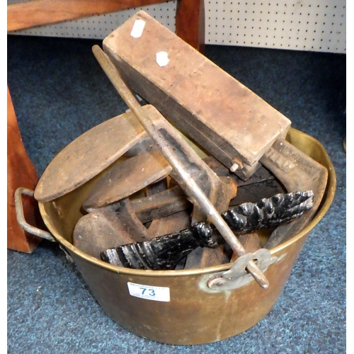 73 - A brass jam pan with contents incl cobblers' lasts.