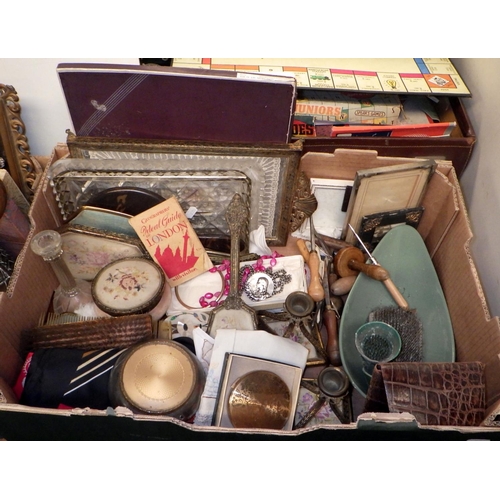 199 - A suitcase containing a collection of games, 1940s and later; dressing table sets and vanity items; ... 