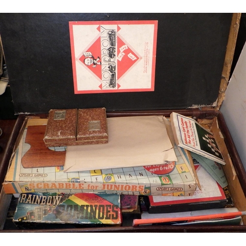 199 - A suitcase containing a collection of games, 1940s and later; dressing table sets and vanity items; ... 