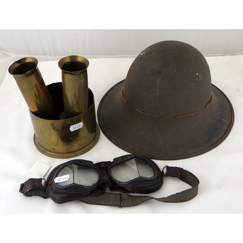 217 - A pair of RAF WW2 MkVIII flying goggles; a British WW2 Civil Defence helmet; four brass shell cases.... 