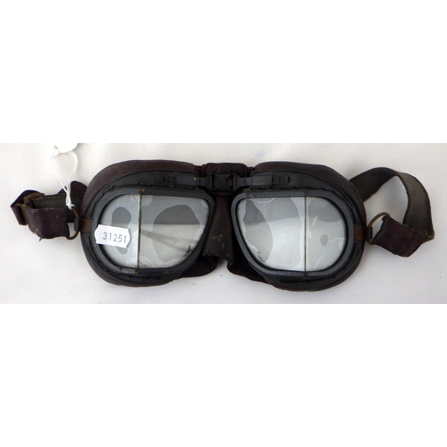 217 - A pair of RAF WW2 MkVIII flying goggles; a British WW2 Civil Defence helmet; four brass shell cases.... 