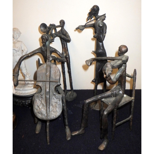 220 - A group of four musician figurines, cast base metal; a figurine of a blacksmith's boy, 36cm tall; a ... 