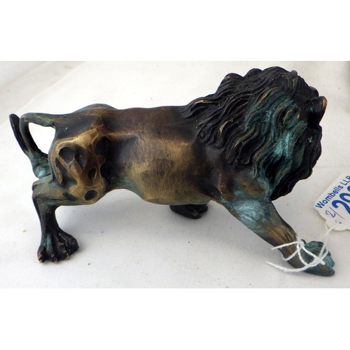 292 - A small cast lion together with a resin recumbent lion (2)