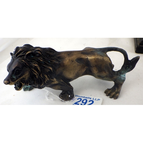 292 - A small cast lion together with a resin recumbent lion (2)