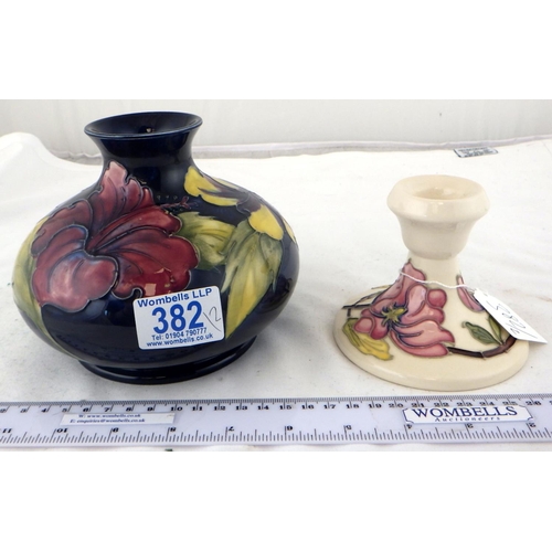 382 - A Moorcroft squat Hibiscus vase with paper label together with a small Moorcroft candlestick (2)