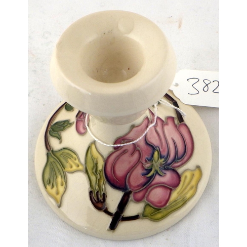 382 - A Moorcroft squat Hibiscus vase with paper label together with a small Moorcroft candlestick (2)