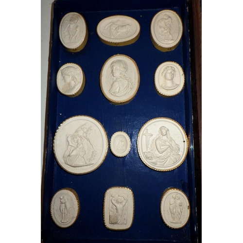 398 - A collection of plaster casts of seals and medals, presented in a two tier wooden case bearing a Rom... 