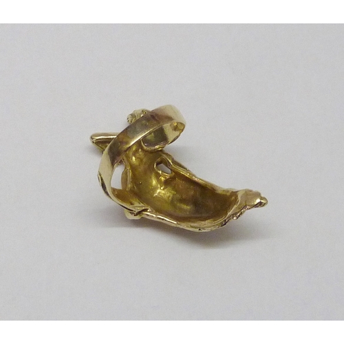 416 - A ring cast with a reclining female figure in classical influence robes, yellow metal marked 14k.  F... 