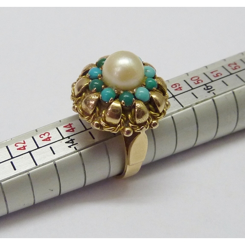 417 - A cluster ring, comprising a central pearl surrounded by a halo of turquoise, unmarked yellow metal.... 