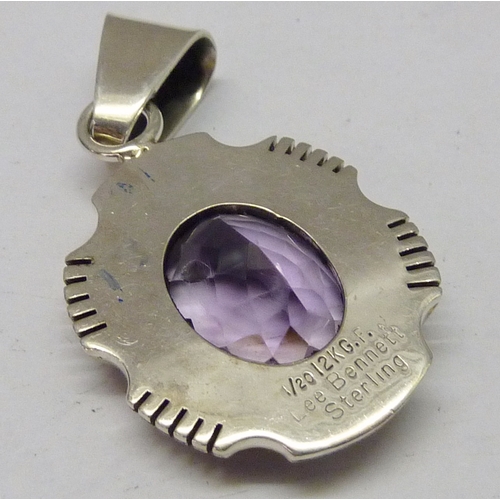 430 - A Lee Bennett Navajo pendant comprising a central synthetic amethyst in a white and yellow metal mou... 