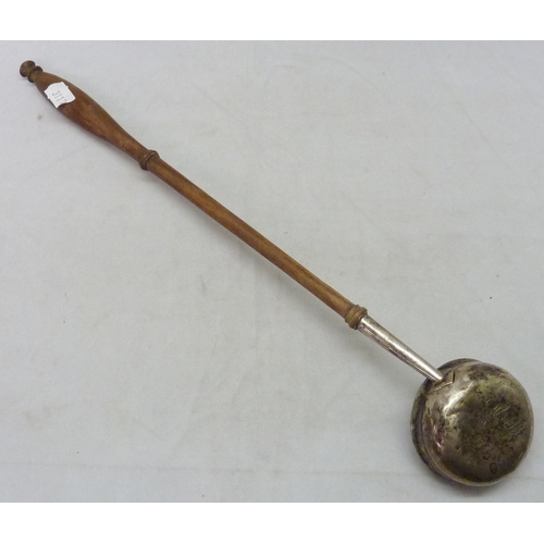 437 - A George III toddy ladle, unmarked white metal and turned wood, the bowl base engraved 