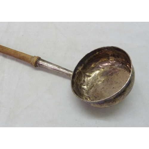 437 - A George III toddy ladle, unmarked white metal and turned wood, the bowl base engraved 