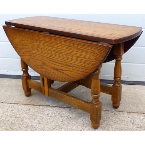 614 - A reproduction drop leaf coffee table, 76cm across