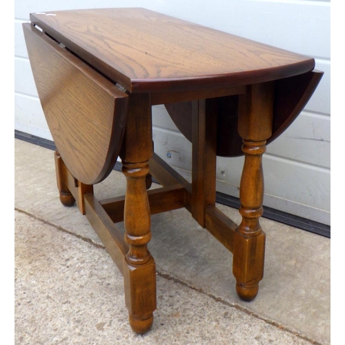 614 - A reproduction drop leaf coffee table, 76cm across