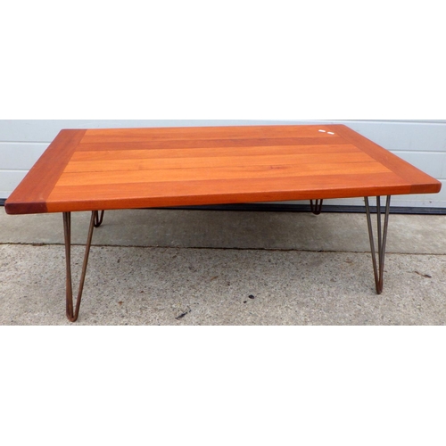 638 - A mahogany coffee table on metal legs, 110cm long