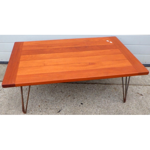 638 - A mahogany coffee table on metal legs, 110cm long