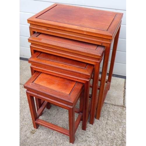 659 - An Oriental hardwood nest of four occasional tables, 51cm wide