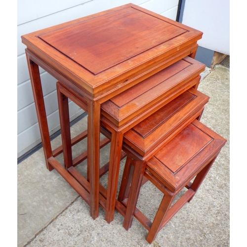 659 - An Oriental hardwood nest of four occasional tables, 51cm wide