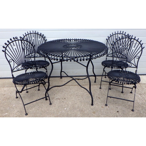 798 - A circular metal garden table with four folding chairs (5)