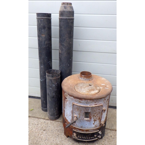 804 - A wood burning stove with flue, 42cm across, 52cm tall