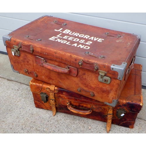 810 - Two brown leather suitcases, largest 75cm long