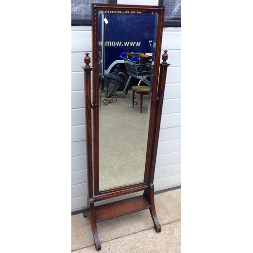 812 - A 1930's oak cheval mirror, 151cm tall