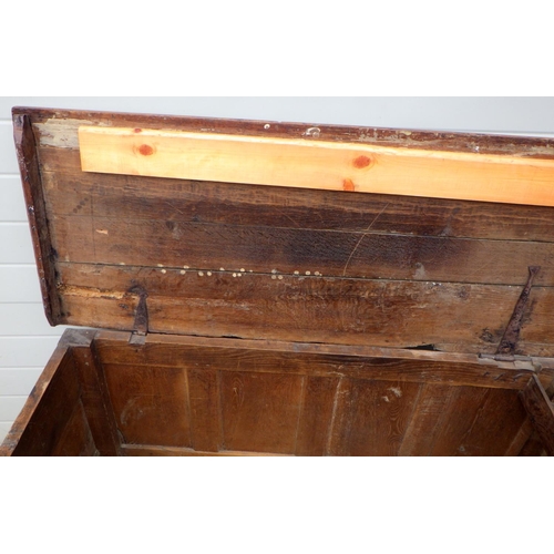 839 - A four panel oak coffer with carved initials E.B, a/f later bottom boards, hinge broken, repairs, 13... 