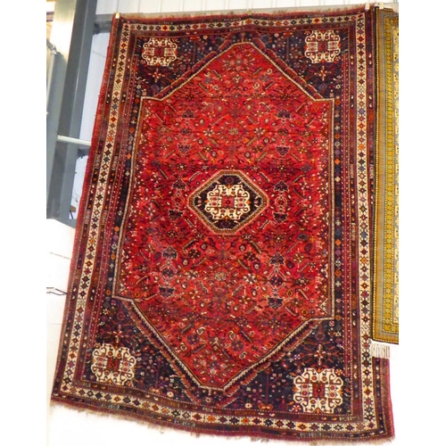 842 - A red ground Qashgai carpet, approx 320cm x 223cm