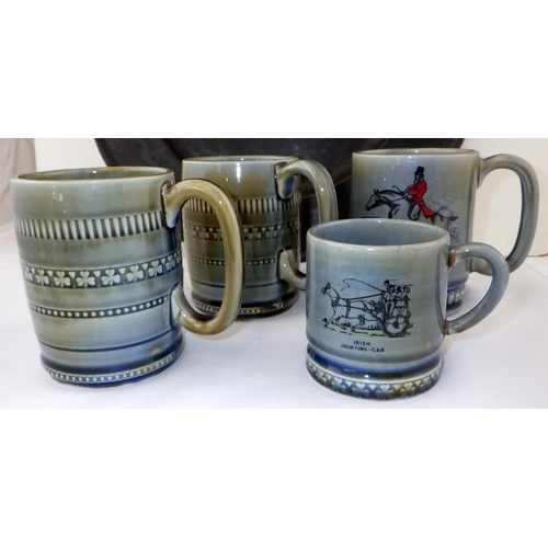 5 - A Hugh Wallis Arts and Crafts pewter charger, 37cm diameter; four Irish pottery mugs. (5)