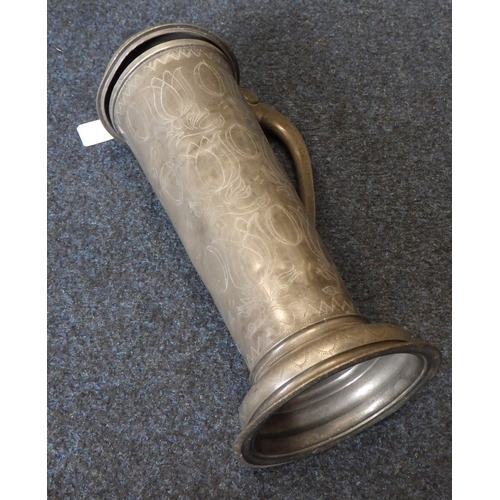 47 - A large pewter tankard / flagon of tall cylindrical form with floral wriggle work decoration. 37cm t... 