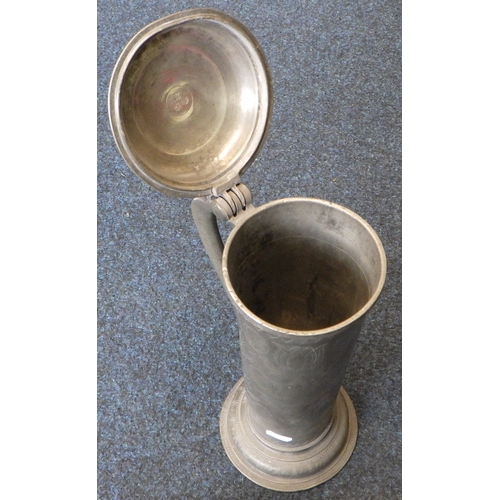 47 - A large pewter tankard / flagon of tall cylindrical form with floral wriggle work decoration. 37cm t... 