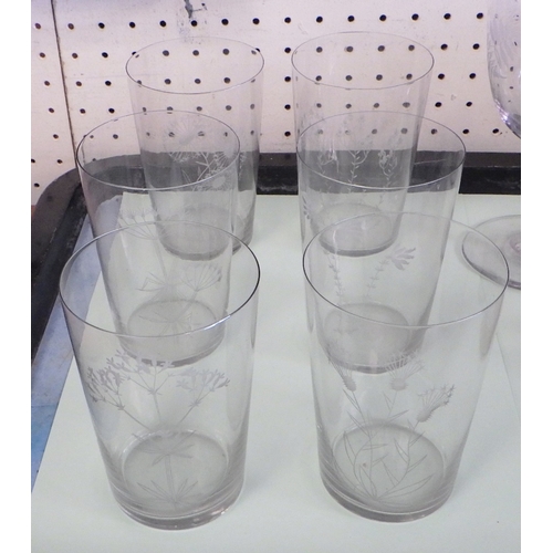 53 - A set of six floral etched glass beakers together with two similar stemmed wine glasses and an etche... 