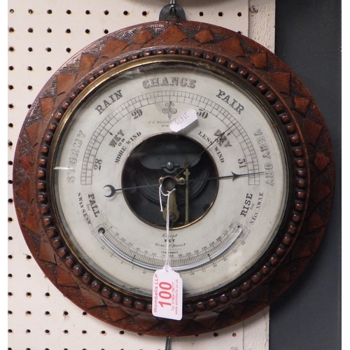 100 - A carved oak J J Wainwright Aneroid barometer 30cm diameter