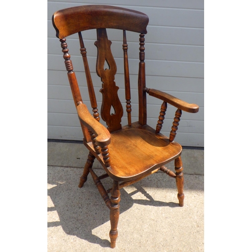 831 - A high back 19thC fiddle back arm chair