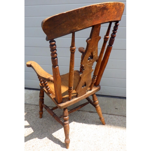 831 - A high back 19thC fiddle back arm chair