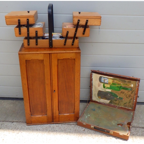 833 - A small 19thC mahogany cupboard together with a concertina sewing box and an artist box (3)