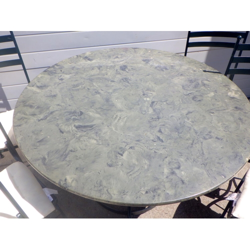 685 - A circular table, 128cm across together with six metal chairs (7)