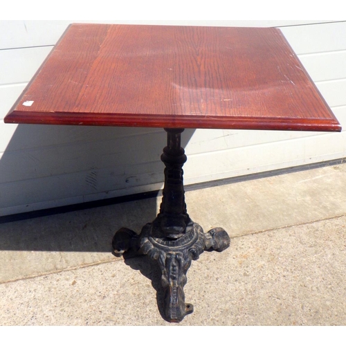 688 - A pub table with cast iron base, 69cm across