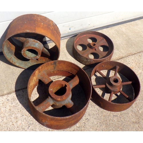 690 - Four cast iron mill wheels, largest 35cm across