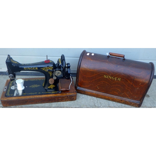 698 - A cased Singer sewing machine