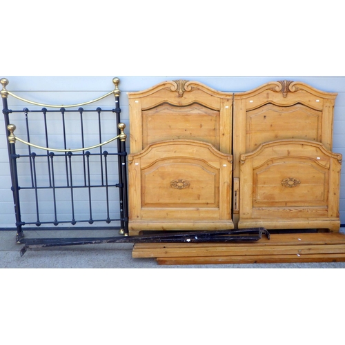 701 - A pine double bed frame, (two singles joined) together with a single bed frame with brass top rail (... 