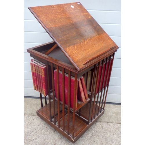 731 - An Edwardian oak revolving bookcase with lecturn top (a/f) together with Punch books, 57cm wide