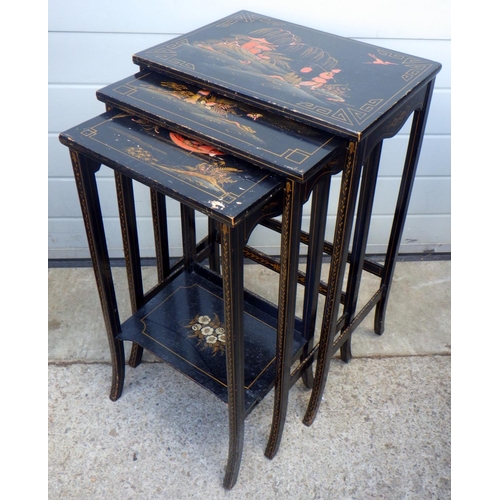 765 - A nest of three black painted, Oriental style nest of tables